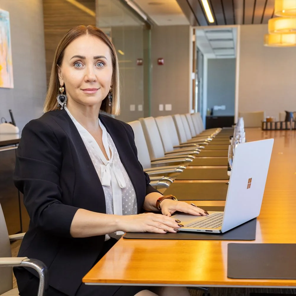 Alexandra Sokolenko working at a laptop in an office